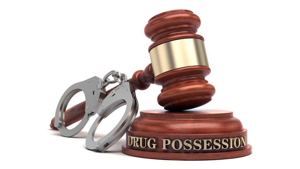 Drug Charges Lawyer in Charlotte & Kinston, NC Criminal defense attorney in Charlotte or Kinston, NC meeting with a client facing drug charges, discussing legal defense strategies in a professional law office.