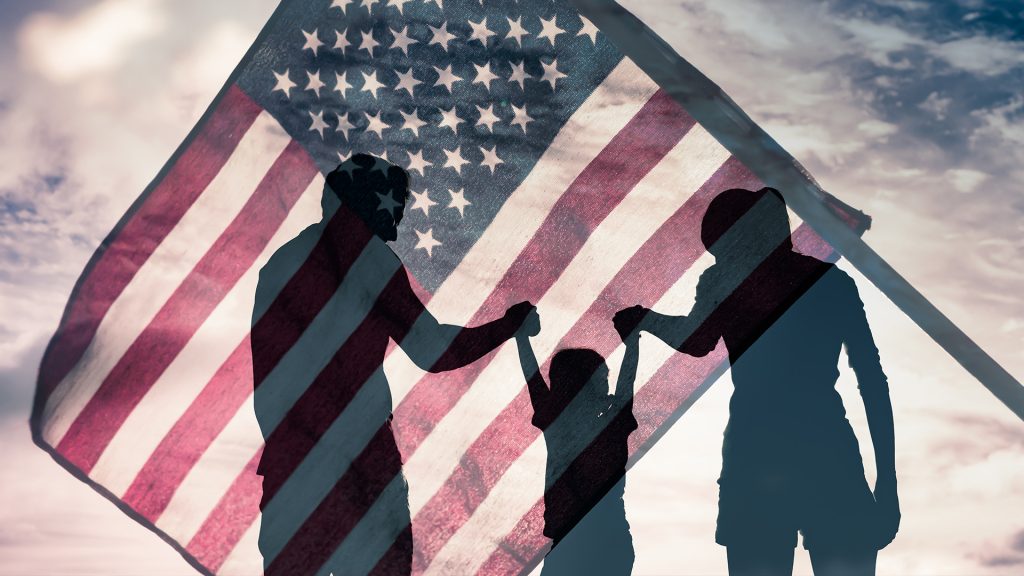 family-based-immigration A family of four—parents and two children—embracing outside a government building, symbolizing family-based immigration and reunification through the U.S. immigration system.