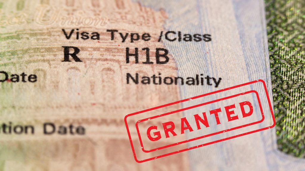 h1b-visa-kinston-nc Immigration lawyer guiding a professional client through the employment-based visa process in a Charlotte or Kinston office, reviewing forms for H-1B or EB-2 petition.