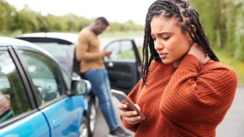 motor-vehicle-accident-lawyer-nc Motor vehicle accident attorney consulting with an injured client in Charlotte or Kinston, NC, reviewing a crash report and discussing a personal injury claim.