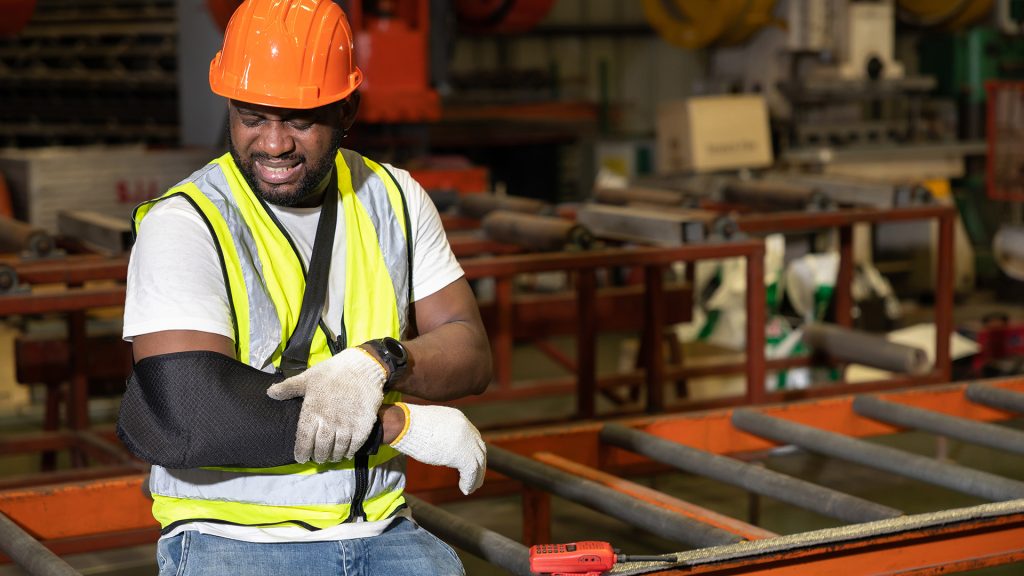 workers-compensation Workers’ compensation attorney in Charlotte or Kinston, NC discussing a job-related injury claim with a client reviewing medical documents and wage loss paperwork.